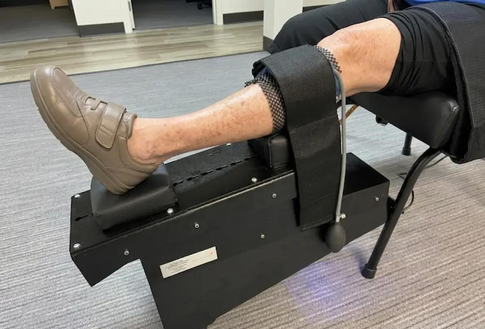 White female having knee decompression done wearing tan shoes