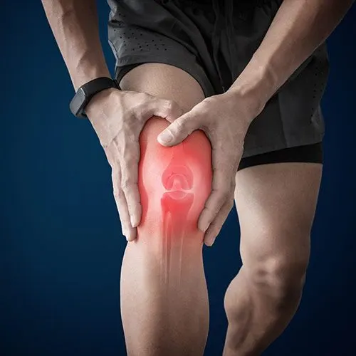white male holding his knee in pain
